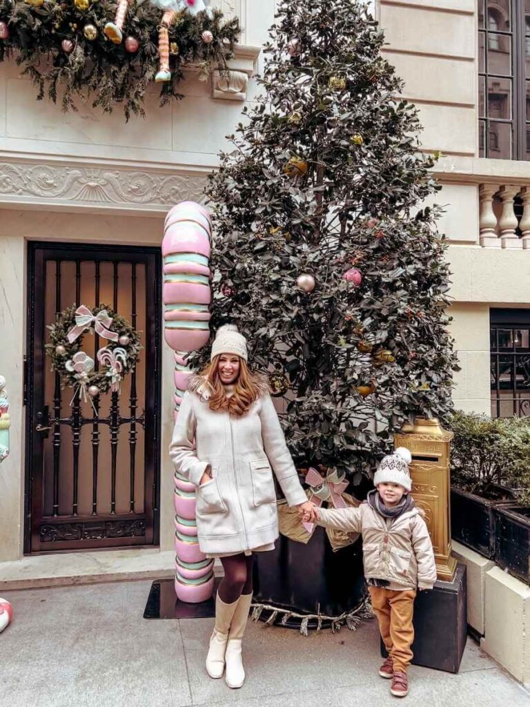 Beautifully decorated townhouse on East 64th Street in NYC during Christmas time with giant candy canes and trees.