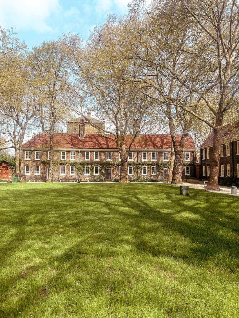 Exterior view of the Museum of the Home in East London, with brick façade and green lawn