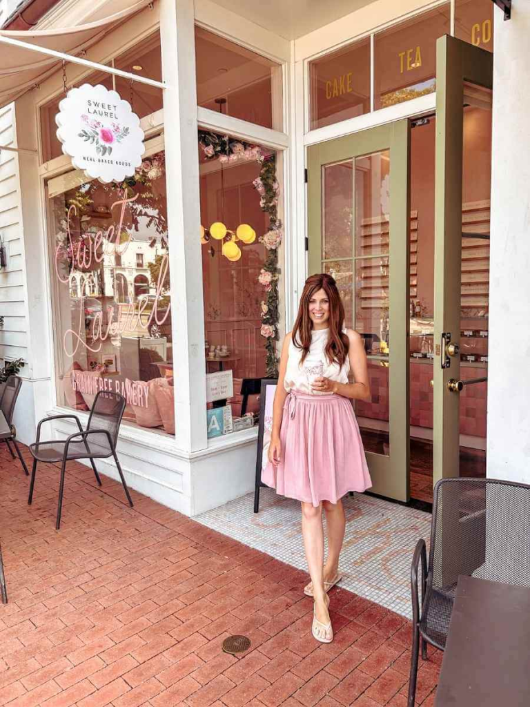 Wearing a white blouse paired with a pink knee-length skirt — a soft and elegant feminine fashion style look for spring.