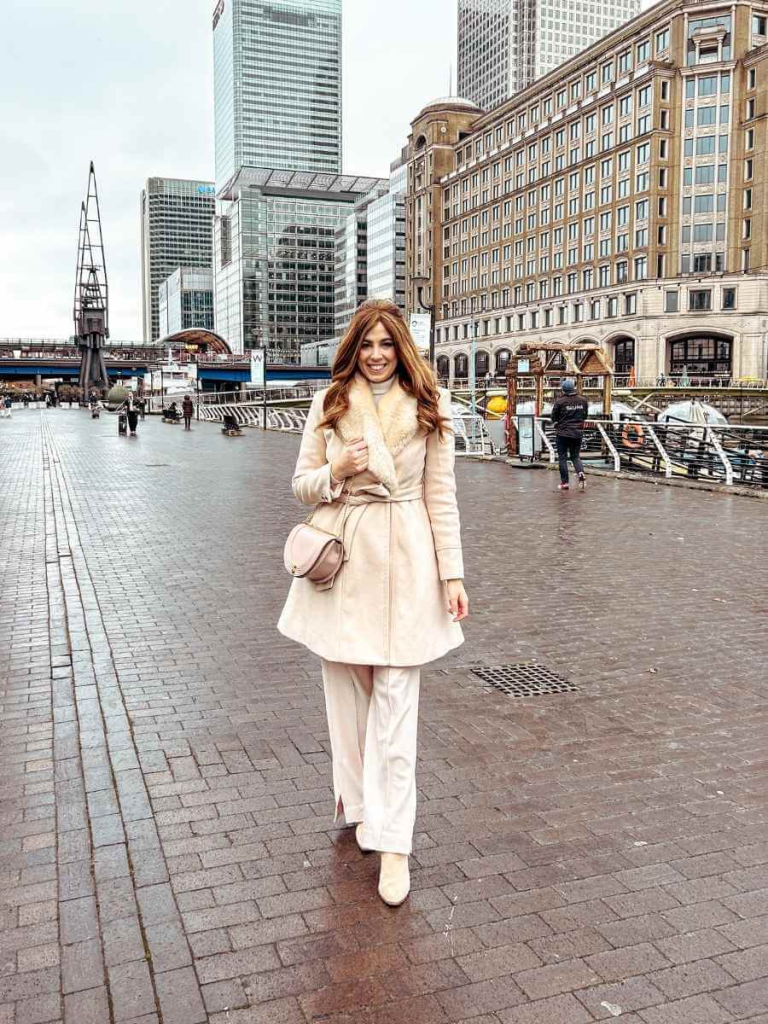 Layered feminine winters outfit featuring a pale pink wool coat and tailored trousers — a chic take on a cold-weather feminine capsule wardrobe.