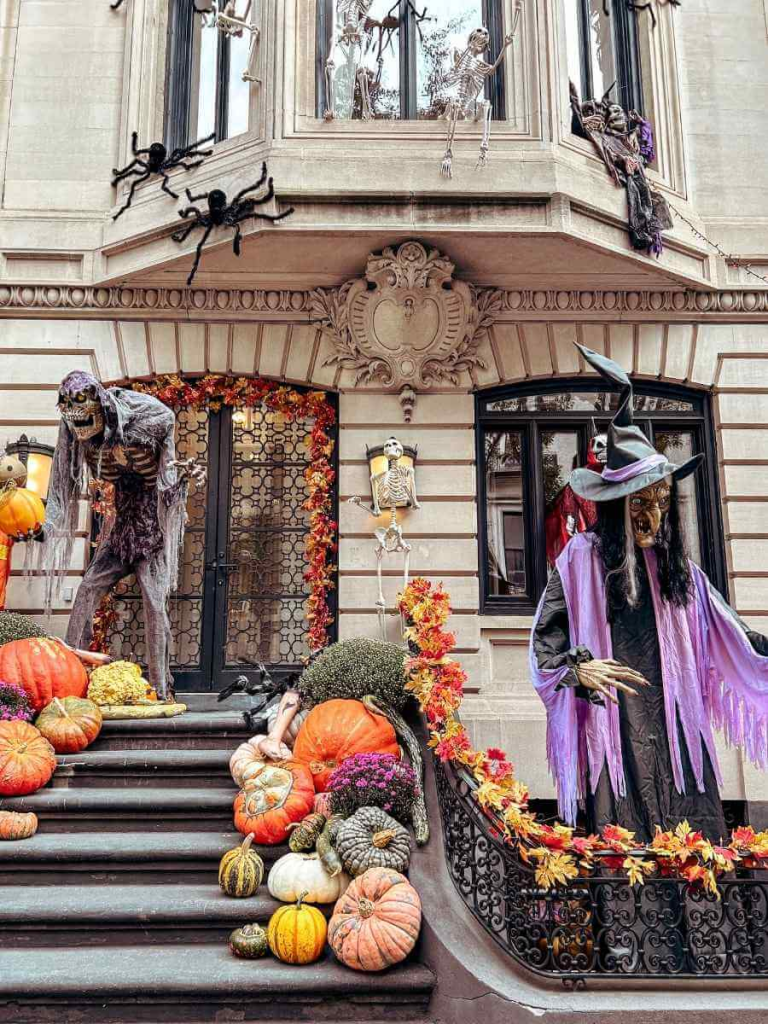 A spooky Upper East Side townhouse decorated with a giant witch and monster for Halloween — classic NYC in October vibes.