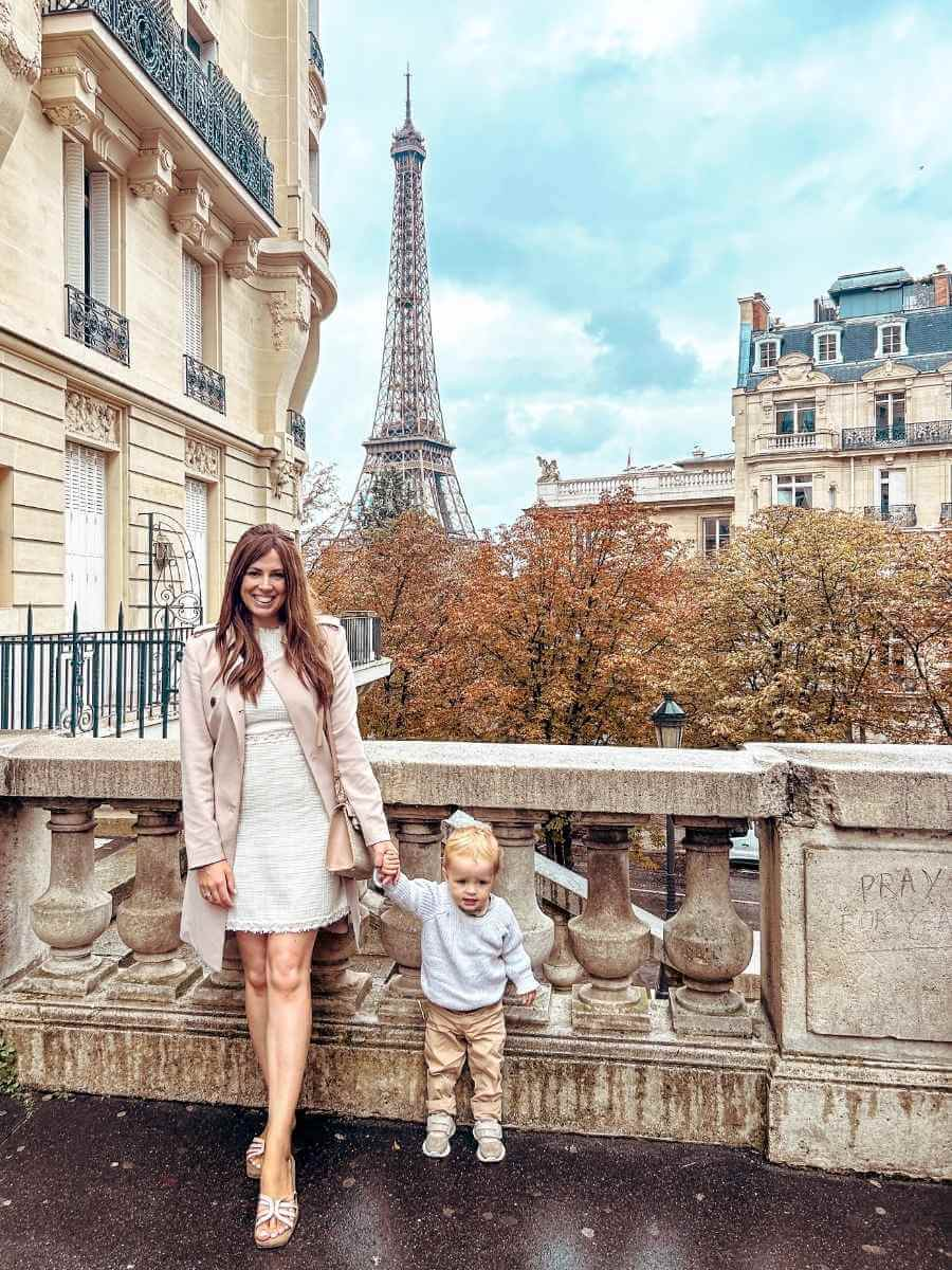 Little white dress styled with a blush pink trench coat — a perfect example of elegant feminine style for transitional weather.