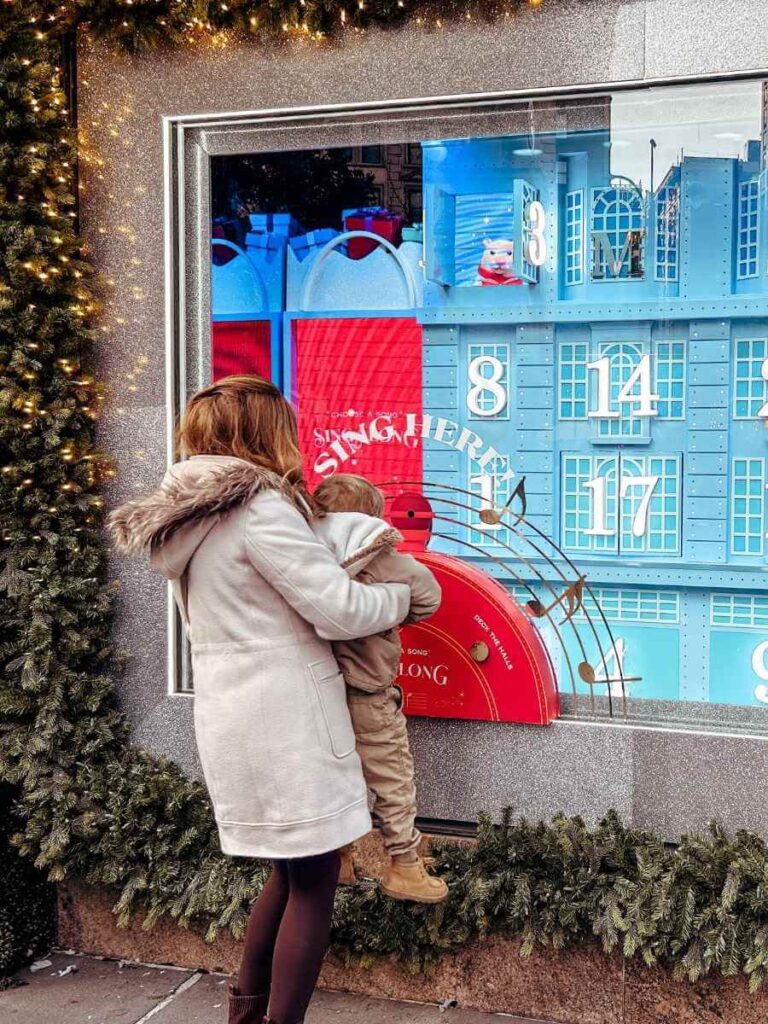 Mum in the City and her son interacting with the magical Macy’s Christmas window displays in New York at Christmas.