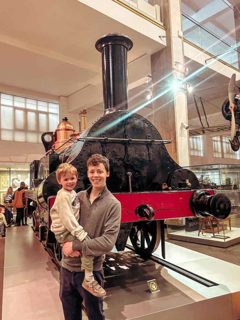 Child and parent exploring a historic train in the Making the Modern World gallery at the Science Museum London.