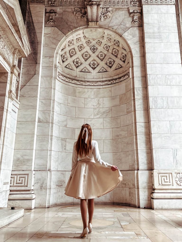 Standing in the archway at the New York Public Library, a classic New York Instagram photo location.