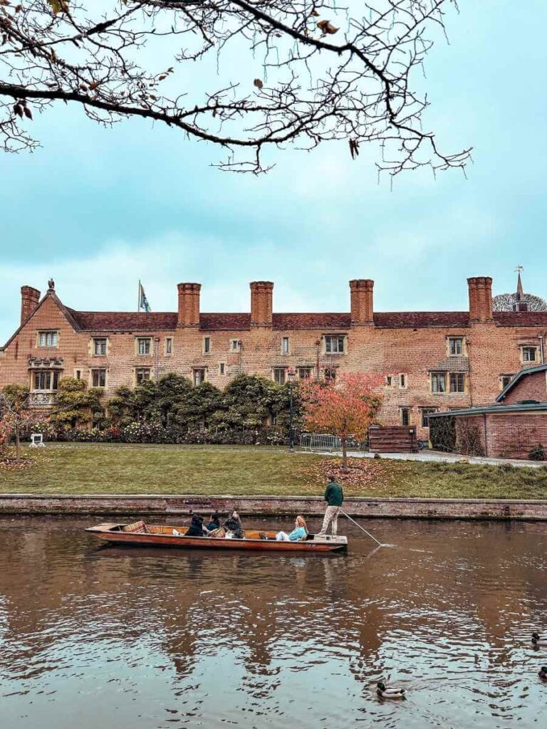 Traditional punting boat gliding down the River Cam, a popular family activity in Cambridge.