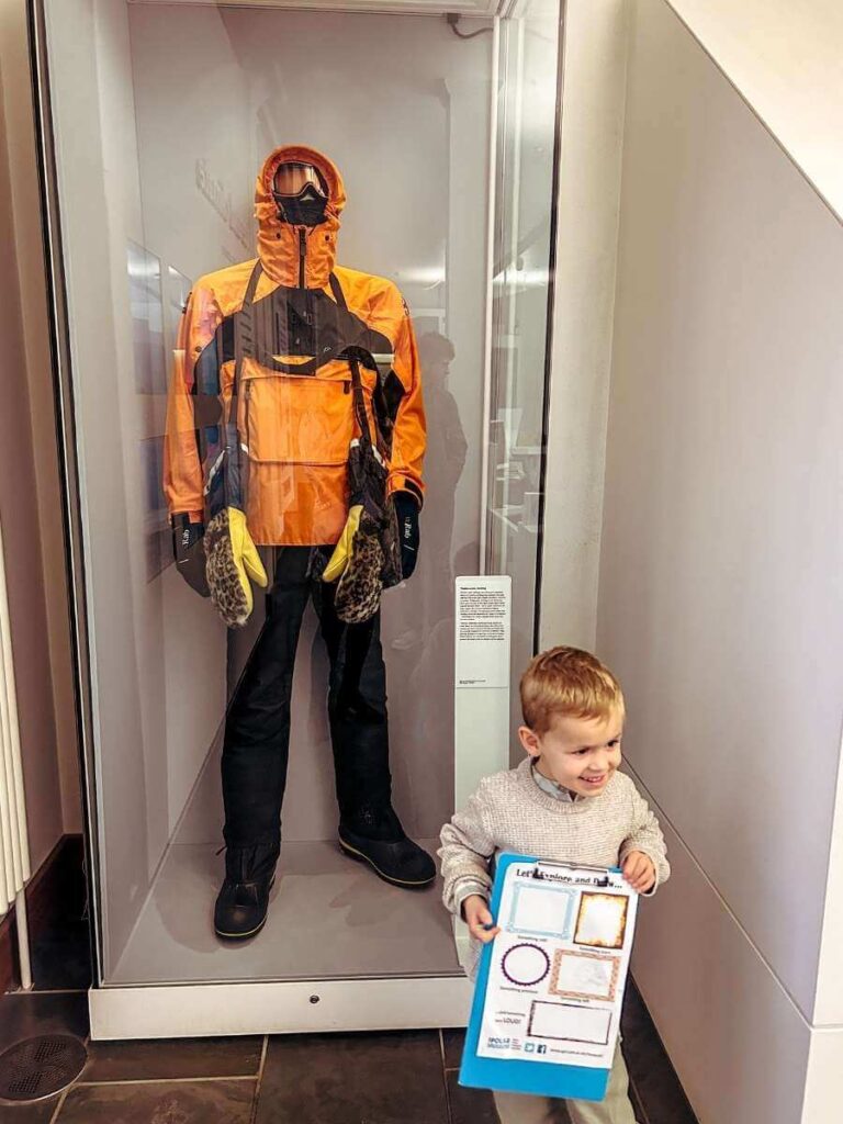 hild completing an activity sheet at the Polar Museum, one of the best things to do in Cambridge with kids on a rainy day.