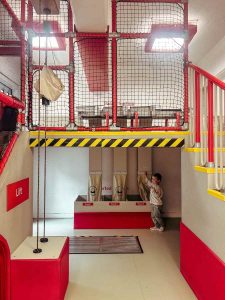 Child sorting mail into sacks at Sorted!, the interactive play zone at The Postal Museum.