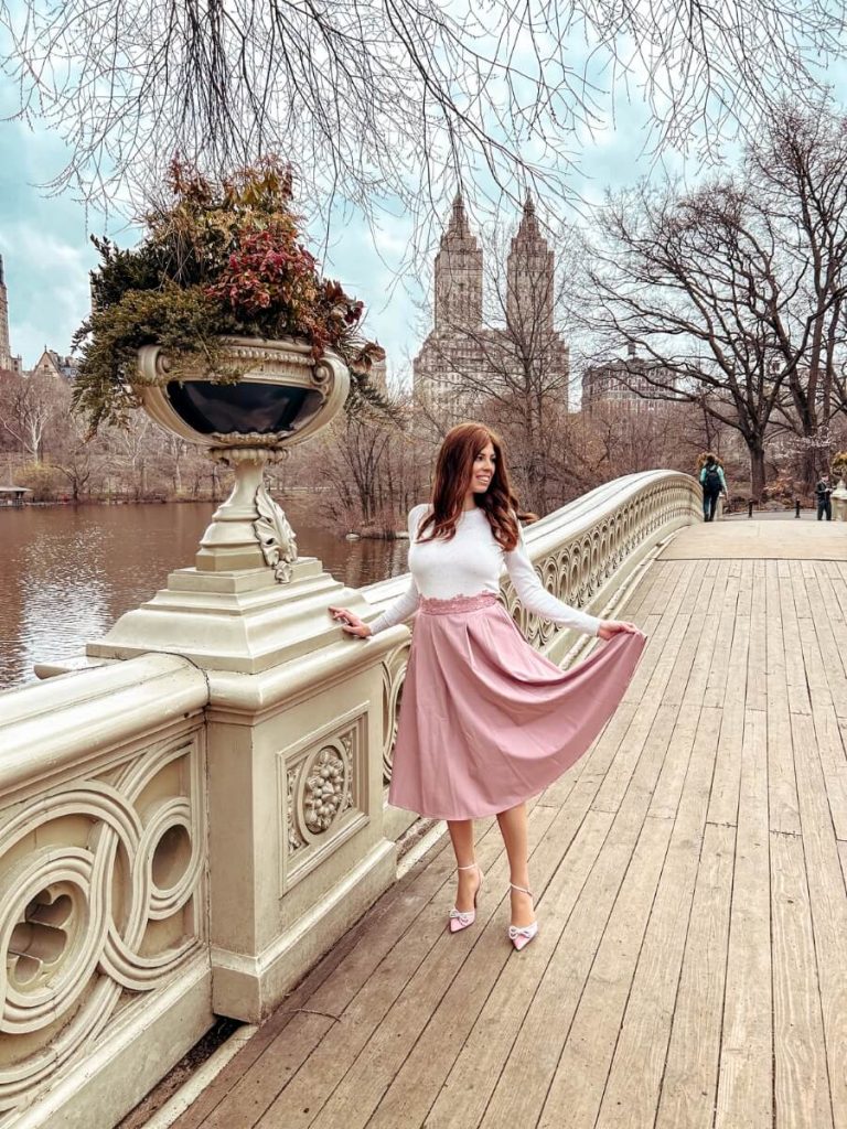Side view of me standing on the Bow Bridge in Central Park, a classic NYC Instagram location.