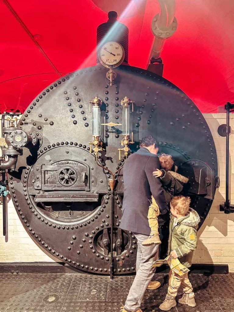 Family looking at the boiler inside the engine room under Tower Bridge during a kids-friendly