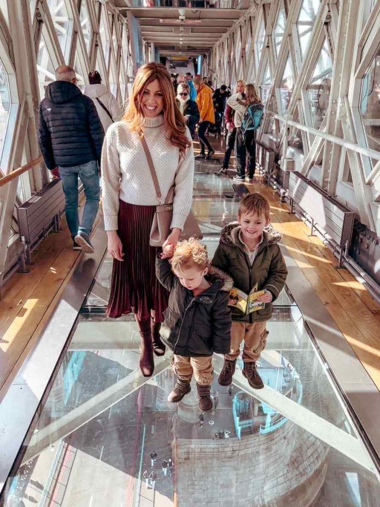 Mum in the City and her and children enjoying the glass walkway experience inside Tower Bridge London