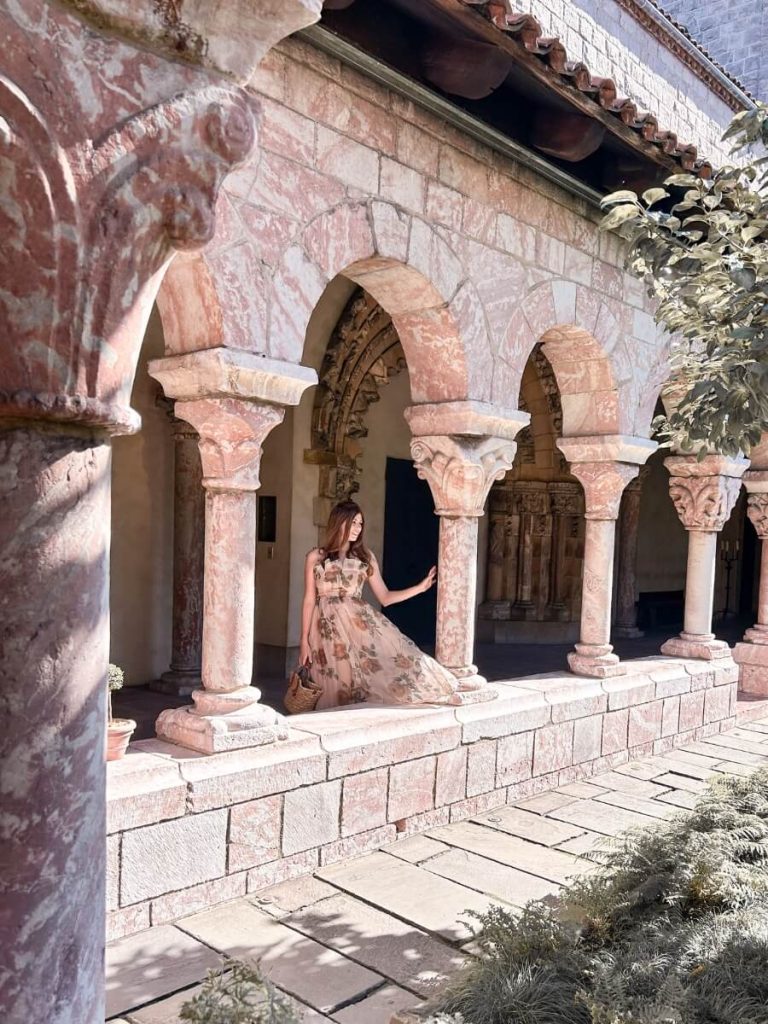 Posing in the stone arches at The Met Cloisters, a unique and secret Instagram spot in NYC.
