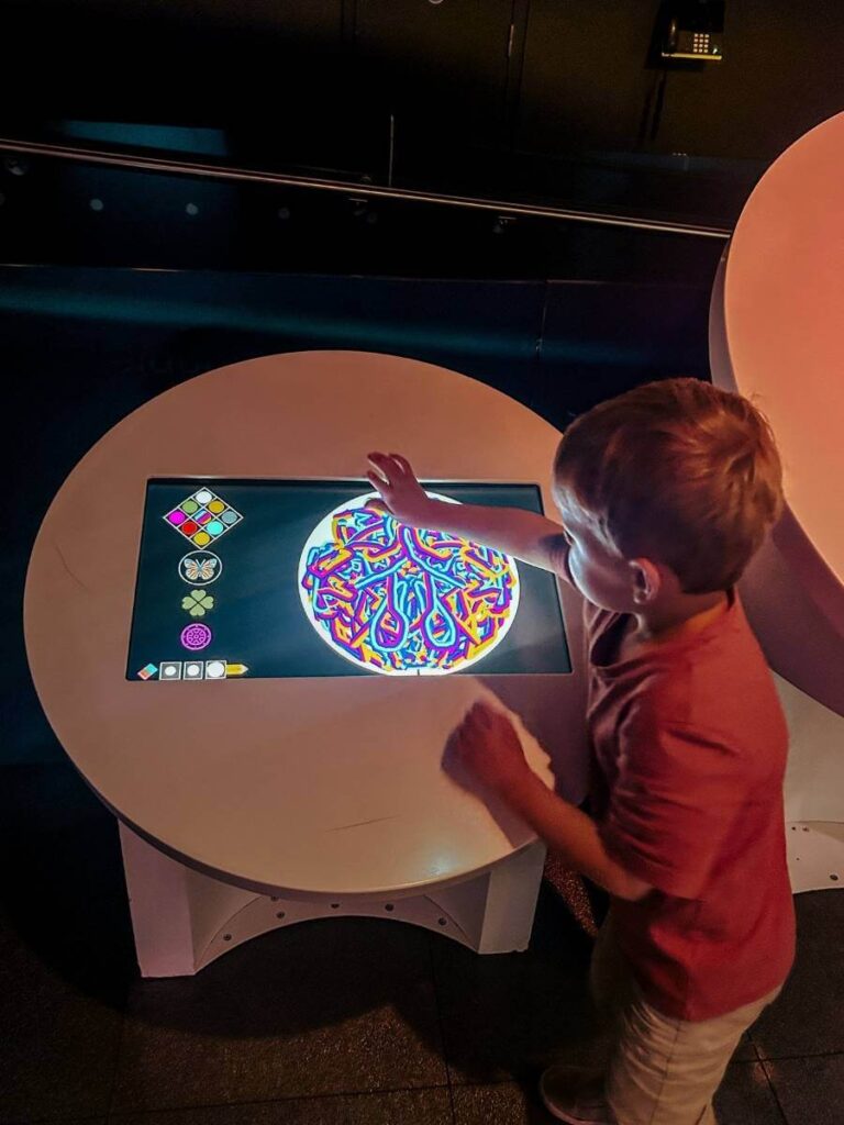 Child using an interactive screen in the Pattern Pod at the Science Museum London, a space designed for toddlers and under 5s.