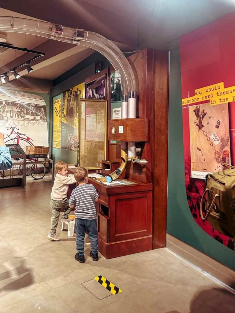 Children using the interactive mail shoot at The Postal Museum in London.