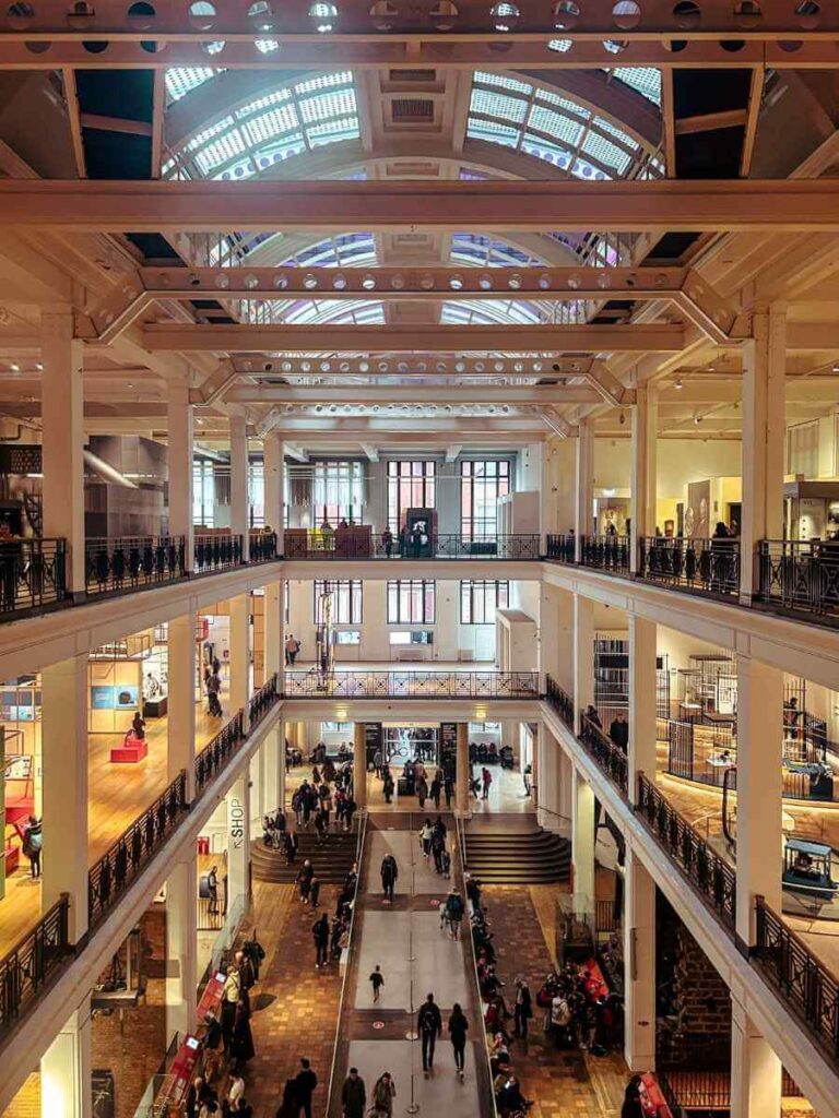 Interior view of the Science Museum London, showing the spacious central gallery filled with exhibits for kids and families.