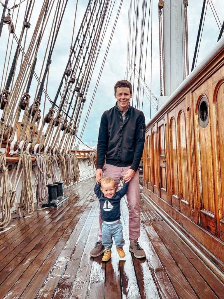 Father and son exploring the Cutty Sark’s top deck together, enjoying the views.