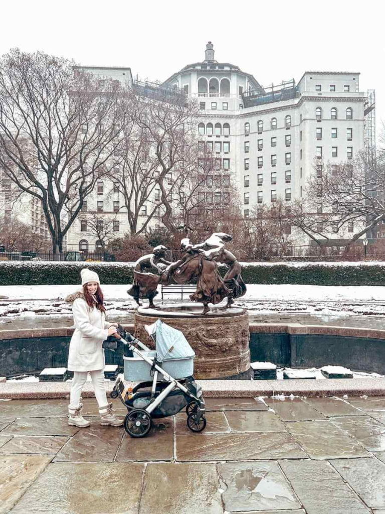 Pushing the UPPAbaby Vista stroller with the bassinet attachment, perfect for first time parents.