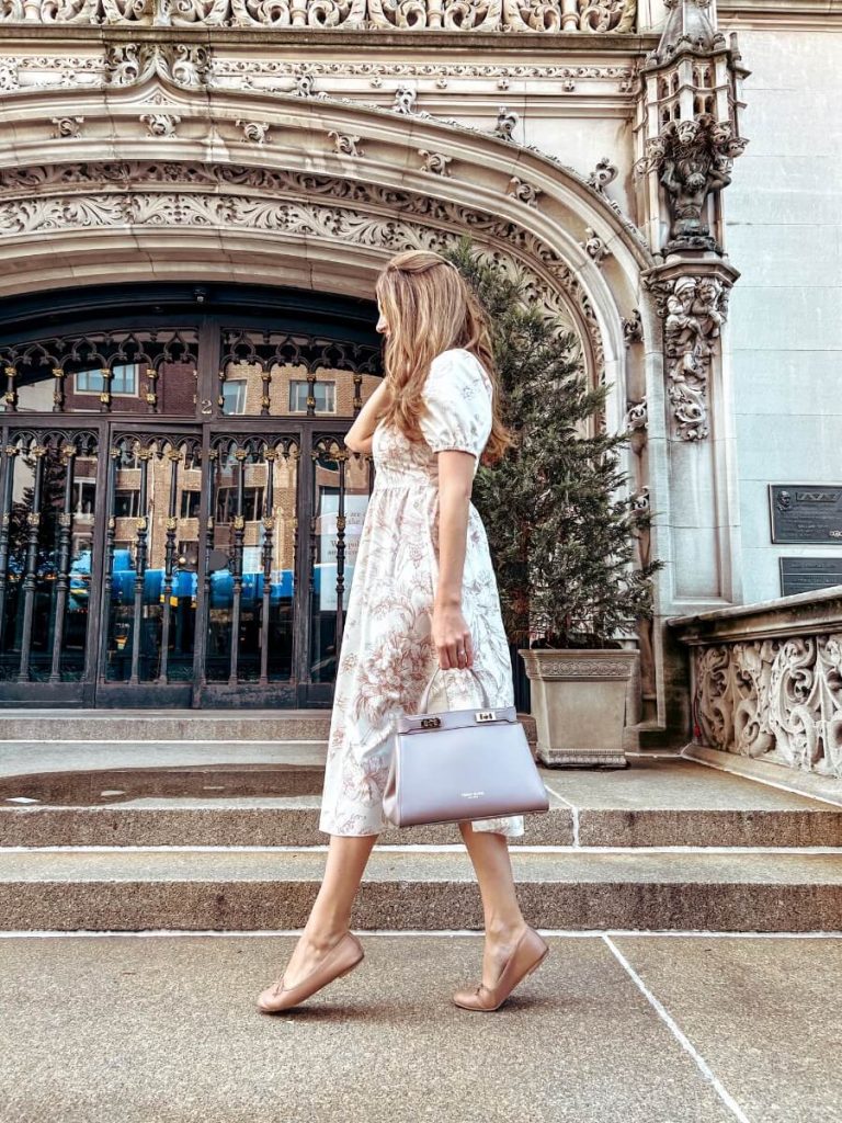 Outside a grand Upper East Side building with beautiful architecture, a chic New York Instagram spot.