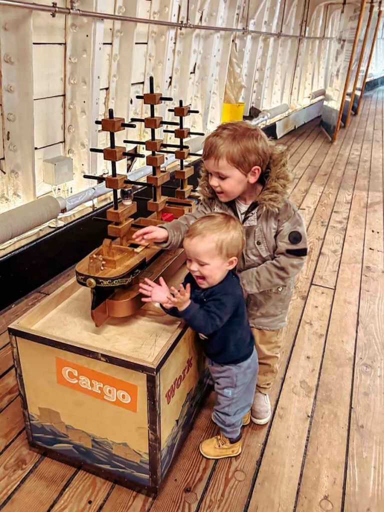 Children playing with a ship-shaped shape sorter on the Cutty Sark, part of the toddler-friendly activities.