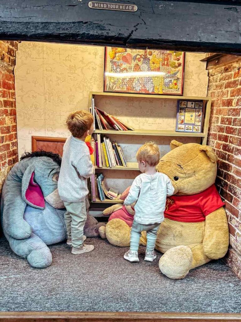 Children exploring the Winnie the Pooh museum at Pooh Corner in Ashdown Forest