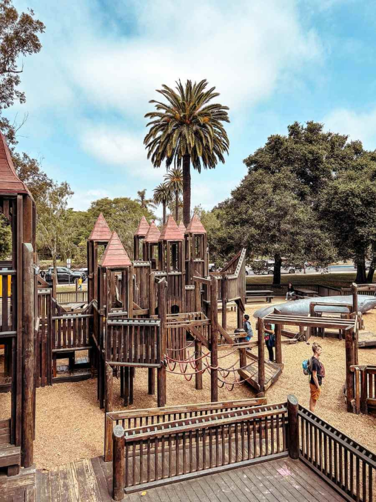 A colourful wooden play structure at Kids World Playground in Santa Barbara, a great thing to do in Santa Barbara with kids.