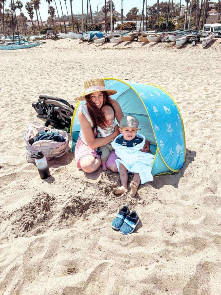 Mum in the City and her kids sheltering from the wind in a beach tent on Ledbetter Beach, Santa Barbara
