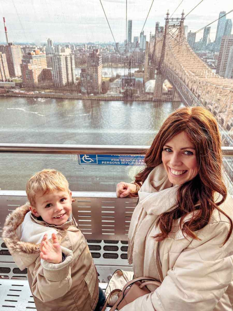 Mum in the City Riding the Roosevelt Island Tramway with her son. A unique New York activity with stunning aerial views.