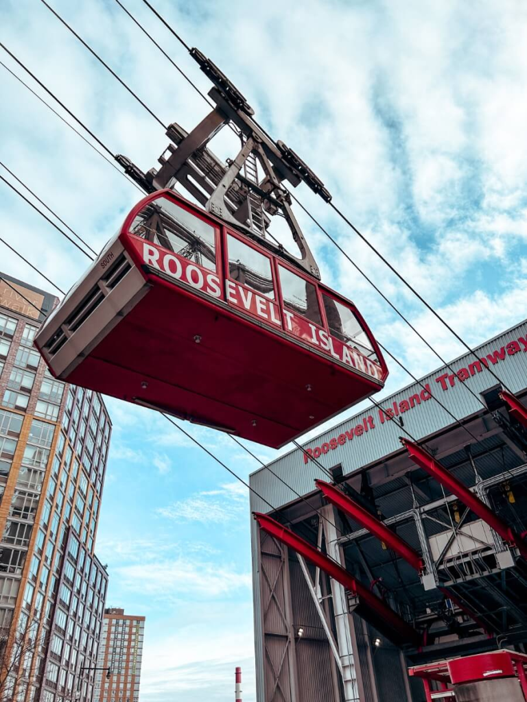 The Roosevelt Island Tram gliding over the East River – a quirky and off the beaten path NYC experience.