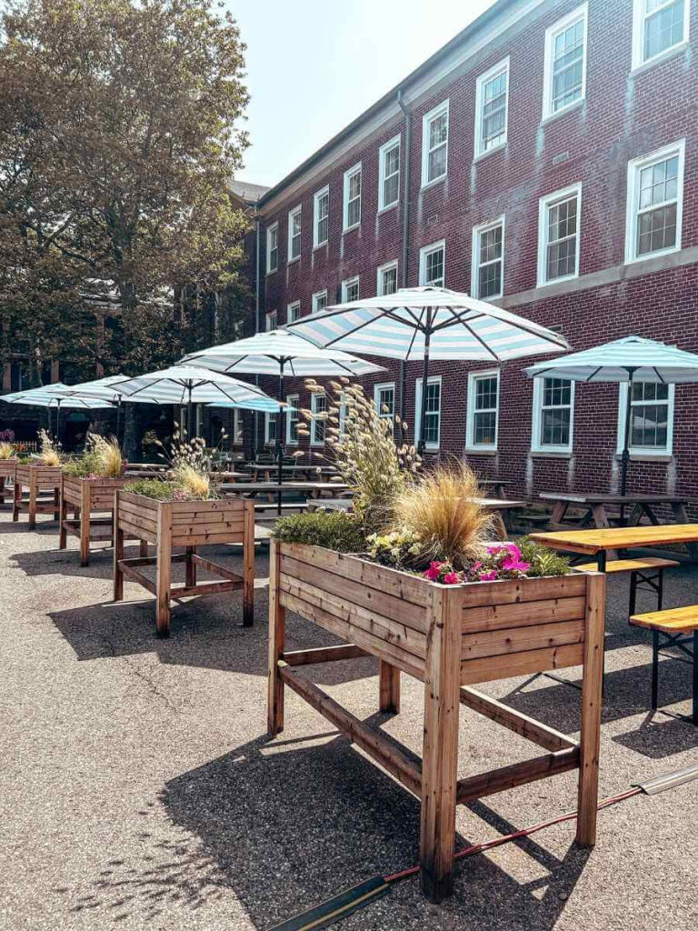 Picnic tables with colorful umbrellas – perfect spot to relax and enjoy lunch while exploring things to do on Governors Island.