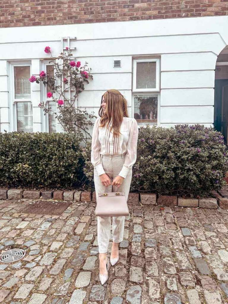 Elegant spring outfit with cigarette trousers, a crisp shirt blouse, kitten heels, and a structured leather bag