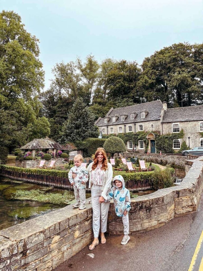 Outside the Swan Pub in Bibury, one of the best villages in the Cotswolds to visit with kids.