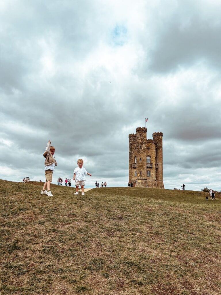 Kids enjoying the view by Broadway Tower, a must-see landmark when spending two days in the Cotswolds