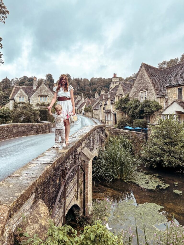 Walking on the bridge in Castle Combe, one of the best Cotswolds villages to visit on a 2 day Cotswolds itinerary. 