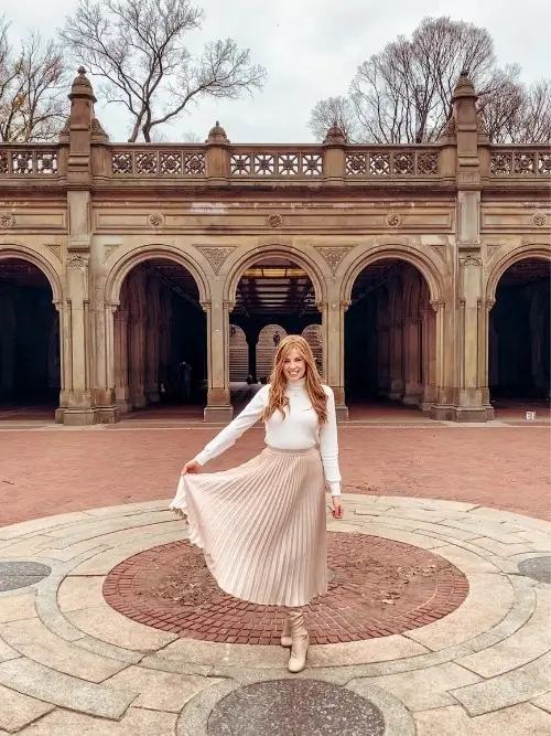 pleated midi skirt styled for autumn or fall with a cream lightweight knit sweater