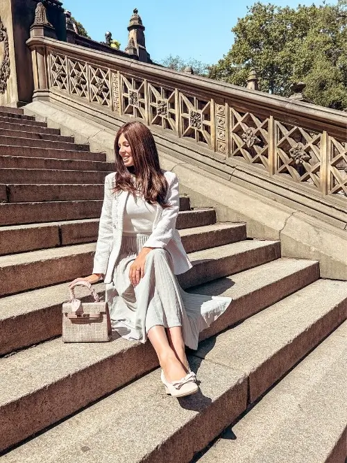 a pleated midi skirt in spring, worn with a tweed blazer 