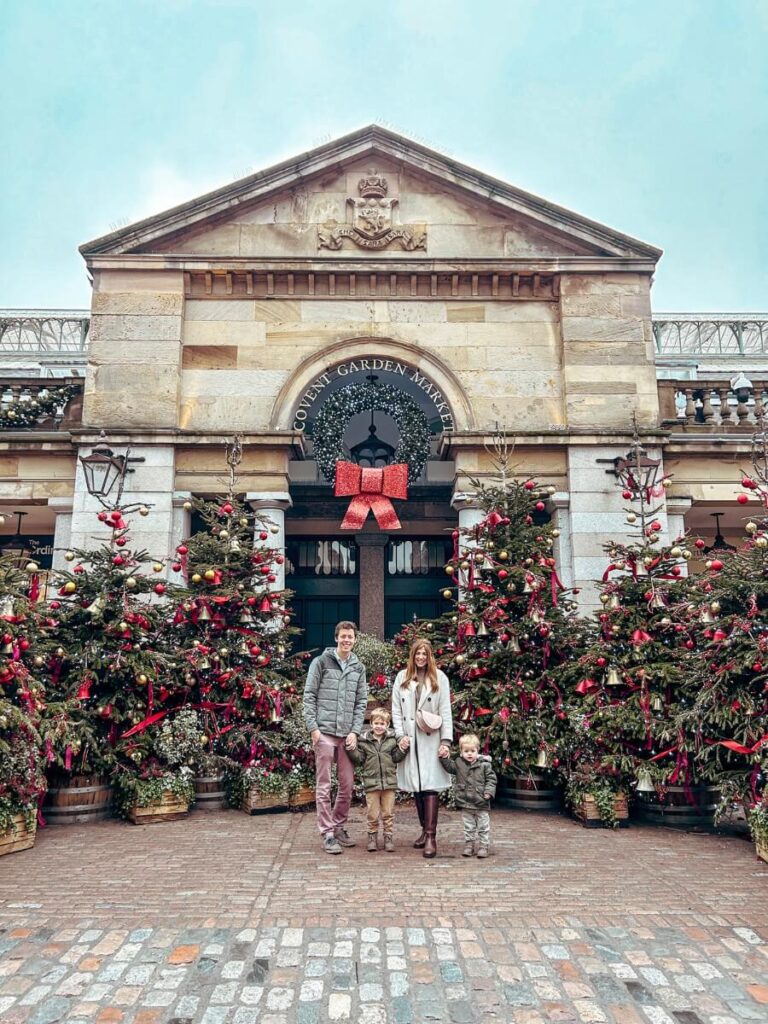A magical family photo in front of Covent Garden's  Christmas tree decorations.