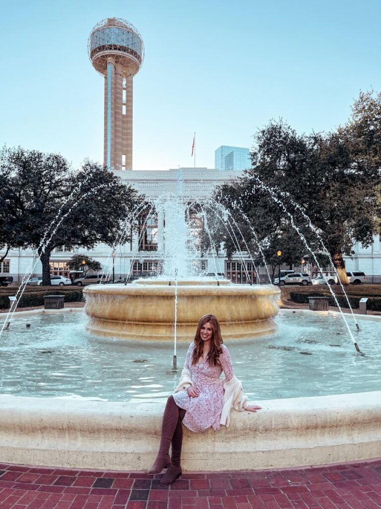 Mum in the City posing in front of the Reunion Tower at Ferris Plaza in Dallas