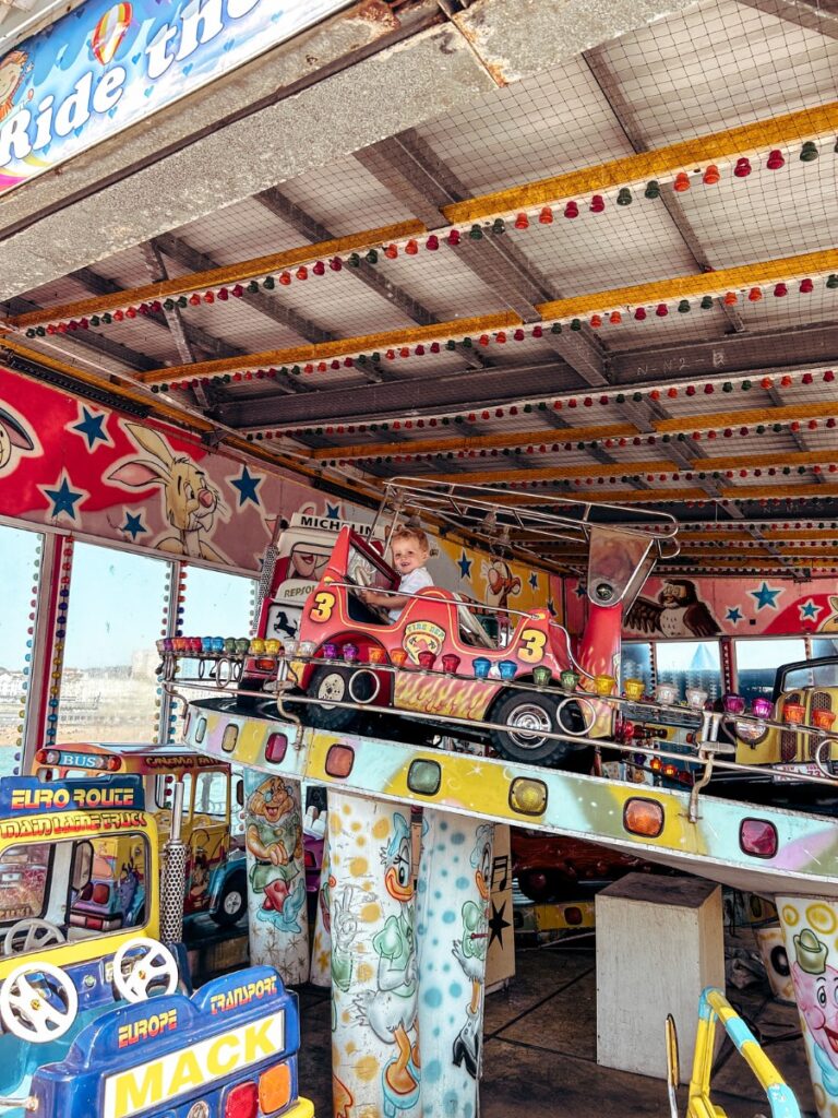 Toddler enjoying a ride on the Pier, a top thing to do in Brighton. 