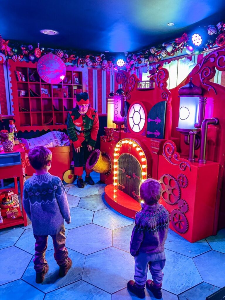 Looking at the toy machine in the elves workshop at the Santsa Grotto in Hamleys London