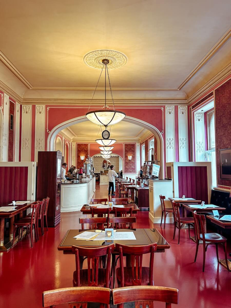 The interior of Cafe Louvre, a must visit restaurant on your Prague itinerary.