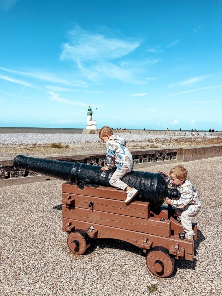 Climbing on the canons by the pier is a fun thing to do in Le Tréport with kids