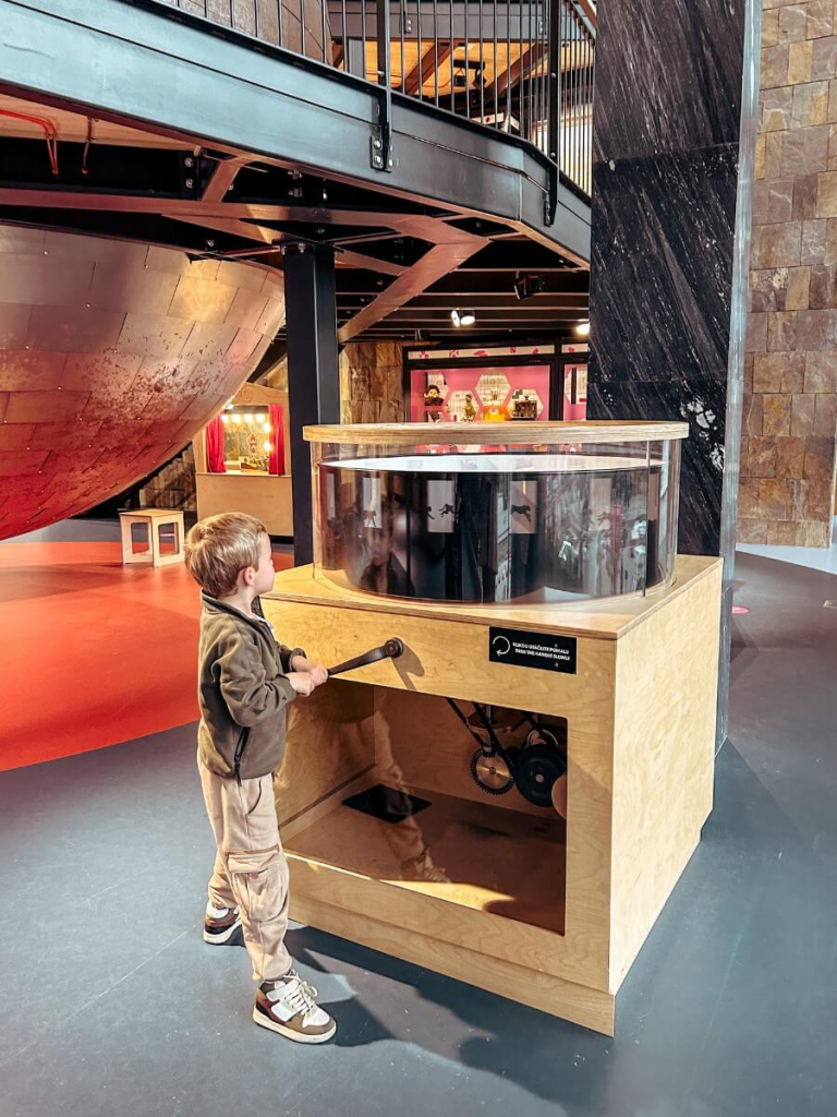 Child exploring the Children's Museum in Prague's National Museum. A fun stop on your Prague with kids itinerary. 