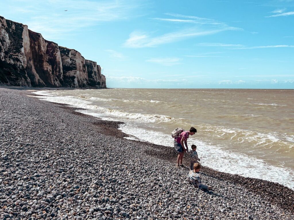 Playing on Le Tréport Beach with the scenic cliffs in the background