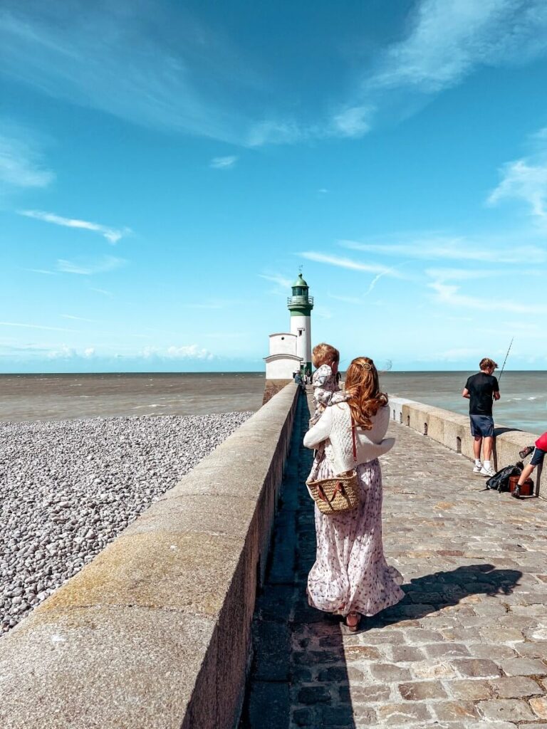Walking the pier towards the lighthouse on a windy day!