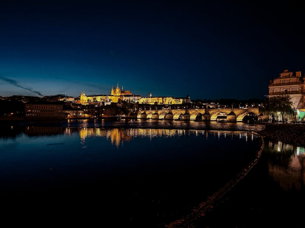 The view of Prague Castle at night from the Vltava Riverbank.