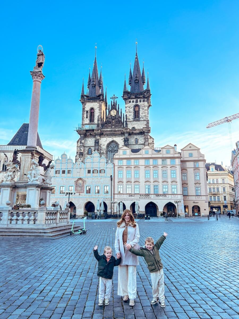 Mum in the City and her children in Prague Old Town Square. A must visit place on your perfect Prague 3 day itinerary. 