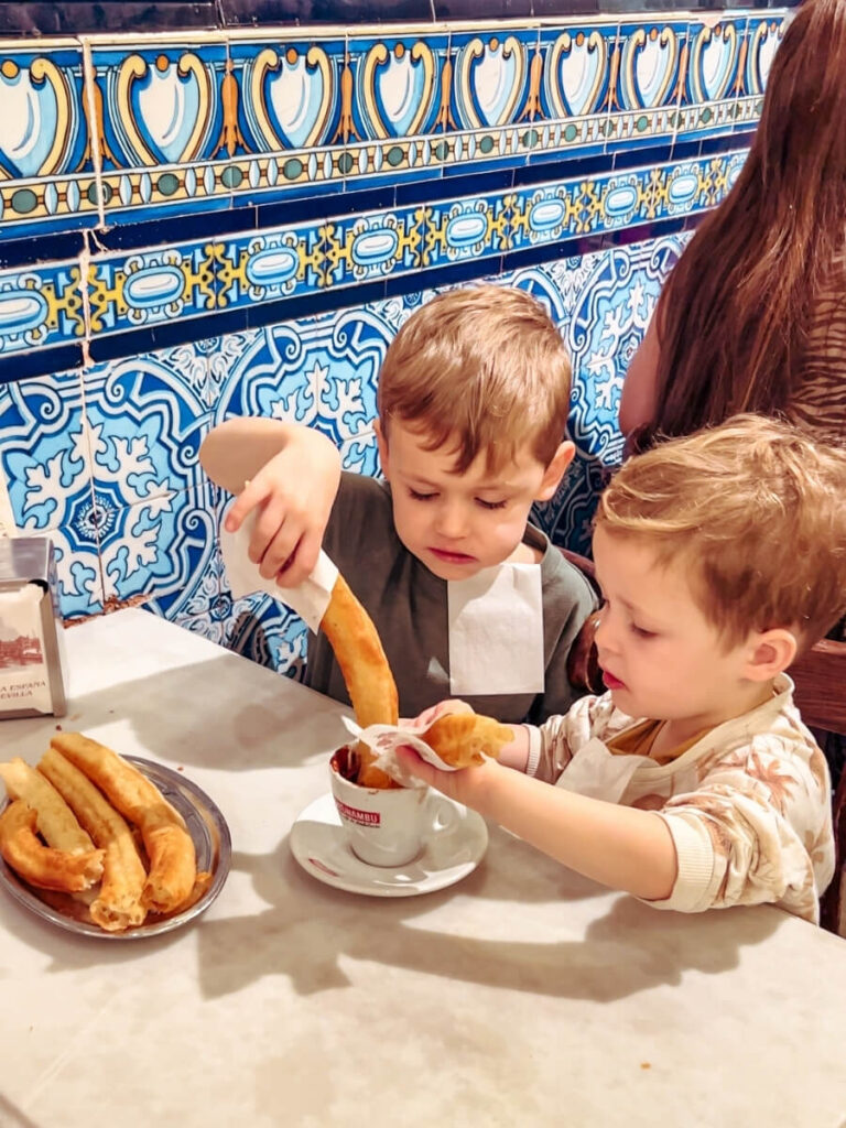 Kids enjoying Churros dipped in Chocolate at Bar El Comercio.