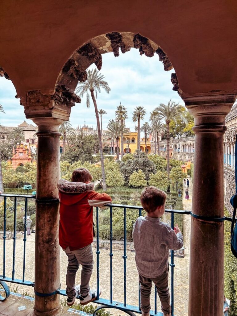 Kids ecploring the gardens at Royal Alcázar of Seville, Spain