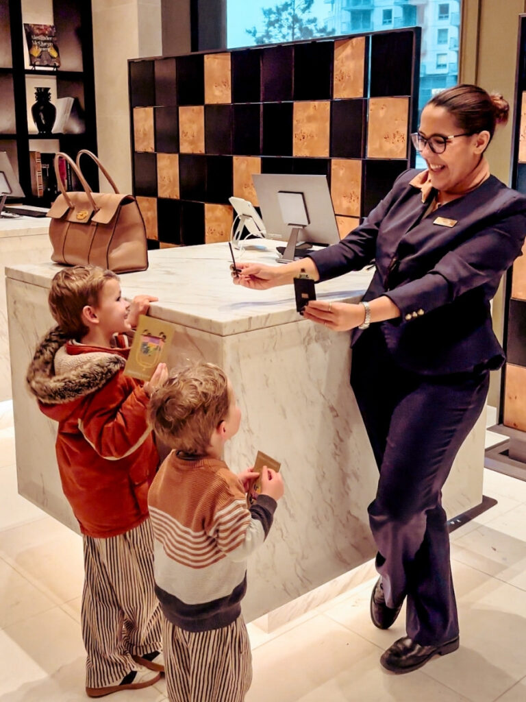Excited children checking in to Park Hyatt London River Thames and getting their special frog keycards.