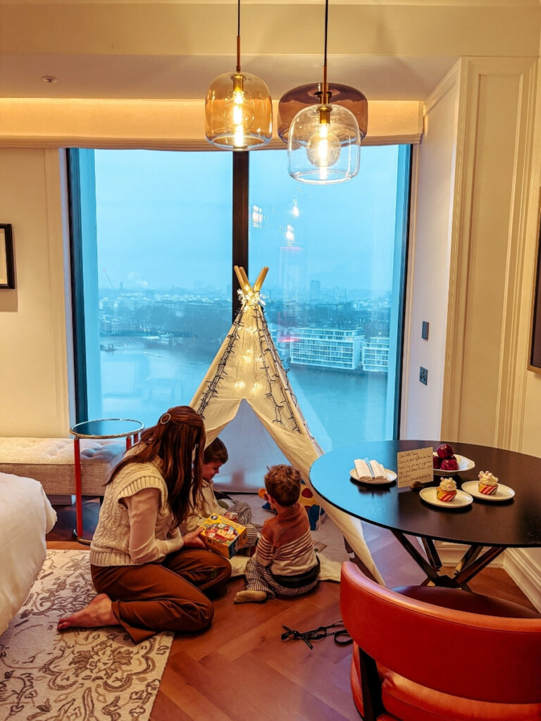 Family excited to see the room at Park Hyatt London, with a tepee tent, toys book and games.